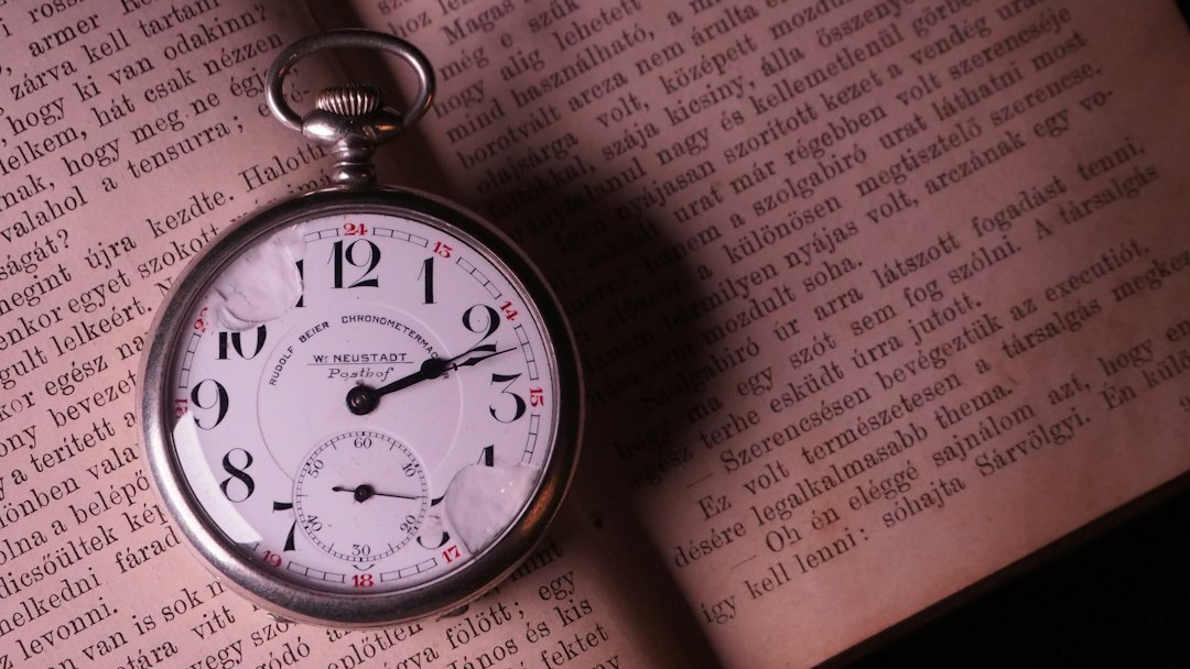 Vintage pocket watch resting on an open Bible